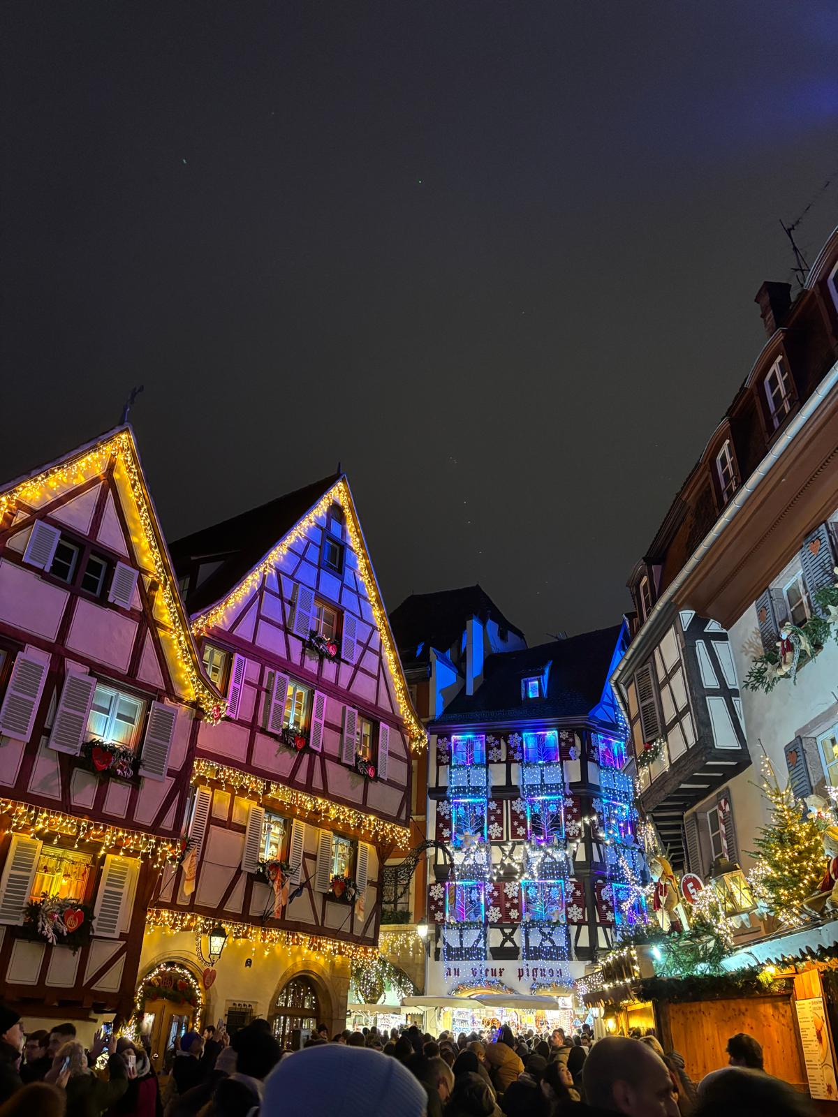 Illuminated traditional half-timbered buildings in Alsace at night